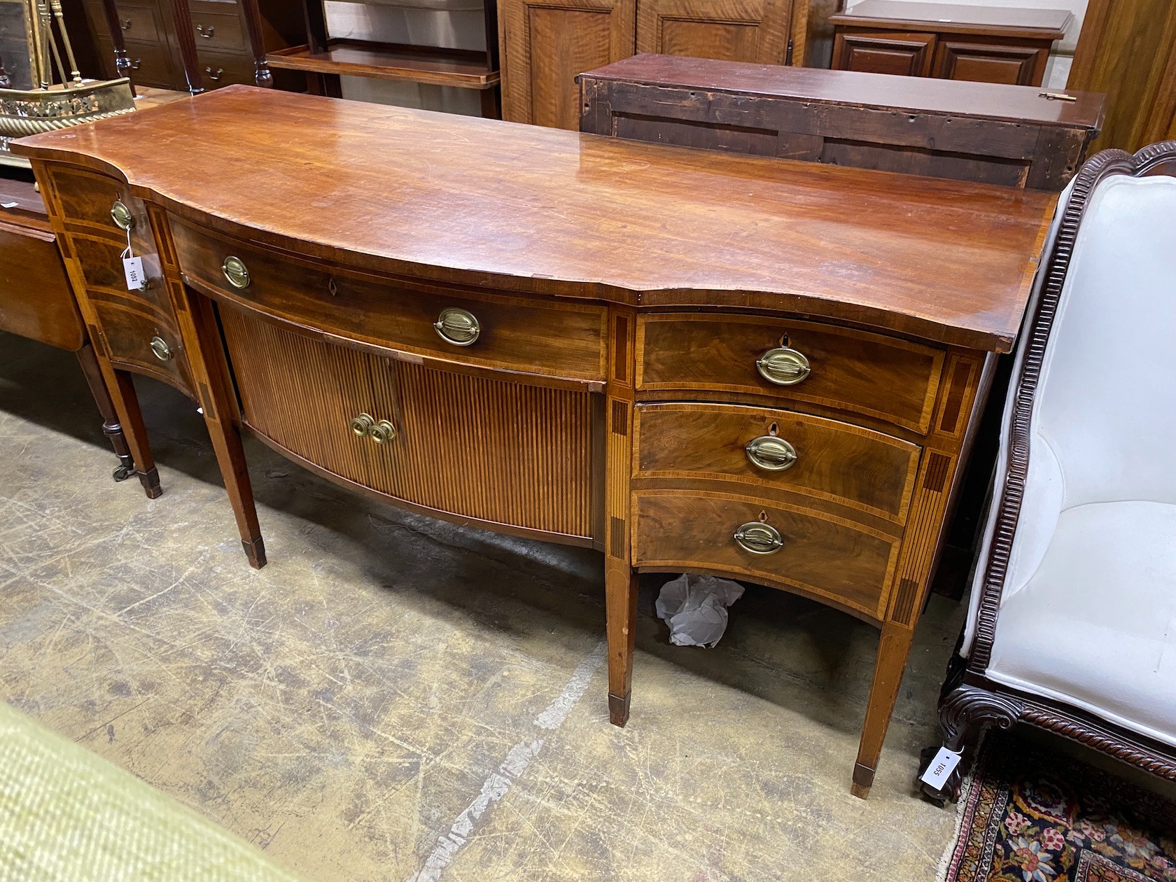 A George III satinwood banded mahogany serpentine sideboard with central tambour compartment, width 199cm, depth 80cm height 95cm